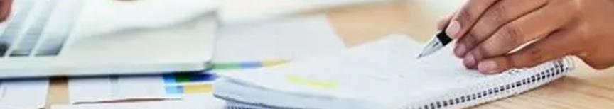 person writing in notebook